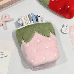 Japanese vintage-style strawberry vertical pencil case, made of soft plush material, available in pink and red colors. The vertical design is stable and won't tip over. It has a large capacity to store stationery, mobile phones, cosmetics, journal materials, and CCD card cameras. It is shockproof, scratch-resistant, portable, and multi-purpose. Sweet, cute, and practical, it is suitable for daily study, office work, and travel