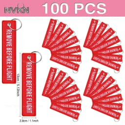 100Pcs “Remove Before Flight” embroidered red fabric keychain with white text – versatile tag for bikes, cars & bags key ring