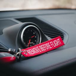 50Pcs Aviation‑style keychain: embroidered red ribbon with white text “Remove Before Flight” for backpacks & cars key ring