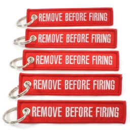 50Pcs Aviation‑style keychain: embroidered red ribbon with white text “Remove Before Flight” for backpacks & cars key ring