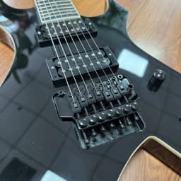 7-String Electric Guitar with Shiny Black High-Gloss Finish and Dual Coil Pickups. Heavy Metal Style. Classic Guitar Shape. Black Fretboard. Embedded Special Pattern Frets. US Warehouse Stock. Free Shipping.