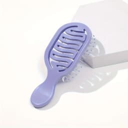 Mini Track Hairbrush, portable hollow design with nylon bristles, ergonomic handle, compact and lightweight—a travel essential.