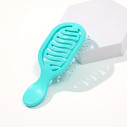 Mini Track Hairbrush, portable hollow design with nylon bristles, ergonomic handle, compact and lightweight—a travel essential.
