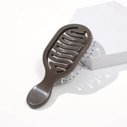 Mini Track Hairbrush, portable hollow design with nylon bristles, ergonomic handle, compact and lightweight—a travel essential.