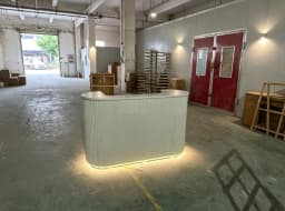 Modern Curved Reception Desk with LED Light Beige Wave Front Desk for Beauty Salon Nail Shop Spa Commercial Furniture