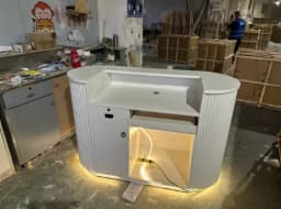Modern Curved Reception Desk with LED Light Beige Wave Front Desk for Beauty Salon Nail Shop Spa Commercial Furniture