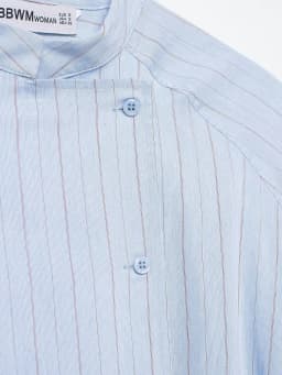 Spring and summer new women's clothing French round neck long sleeved asymmetrical hem flip chest pocket striped shirt