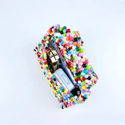 European and American same niche handmade color-blocked pearl triangle bag, fashionable and versatile hand-held bead bag