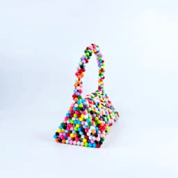 European and American same niche handmade color-blocked pearl triangle bag, fashionable and versatile hand-held bead bag
