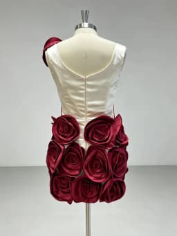Elegant Ivory Dress With Red Embellishments And Large Rose Accents On Skirt And Shoulder Exudes Glamour And Sophistication Perfe