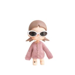 For the Zsiga doll dress it features a stylish pair of sunglasses a pink sweater and a cute design reminiscent of a grandma.