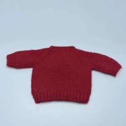 For the Zsiga doll dress it features a stylish pair of sunglasses a pink sweater and a cute design reminiscent of a grandma.