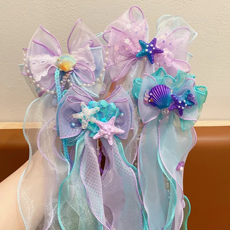 A mermaid princess bow hair clip with a floating gauze pair for a birthday performance hair accessory and veil
