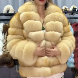 Lady's fashionable warm natural fur coat with a collar for warmth, luxurious high street outerwear