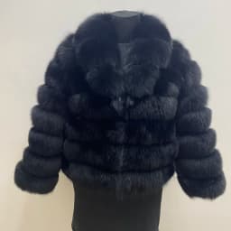 Lady's fashionable warm natural fur coat with a collar for warmth, luxurious high street outerwear
