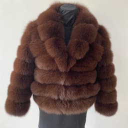 Lady's fashionable warm natural fur coat with a collar for warmth, luxurious high street outerwear