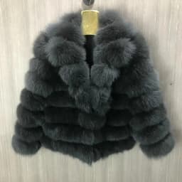 Lady's fashionable warm natural fur coat with a collar for warmth, luxurious high street outerwear