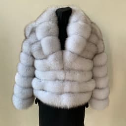 Lady's fashionable warm natural fur coat with a collar for warmth, luxurious high street outerwear