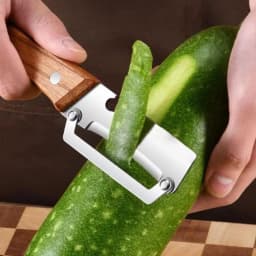Stainless steel peeler with wooden handle for peeling and slicing fruits and vegetables | Durable and smooth operation