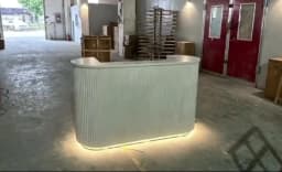 Modern Curved Reception Desk with LED Light Beige Wave Front Desk for Beauty Salon Nail Shop Spa Commercial Furniture