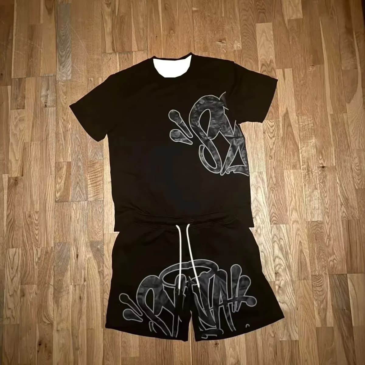 2026 Summer New Style Unisex Abstract Graffiti Graphic 2 Piece Tracksuit Black Tee and Elastic Waist Shorts for Kids Streetwear