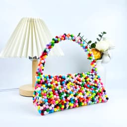 European and American same niche handmade color-blocked pearl triangle bag, fashionable and versatile hand-held bead bag
