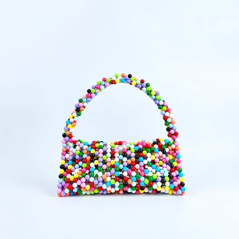 European and American same niche handmade color-blocked pearl triangle bag, fashionable and versatile hand-held bead bag