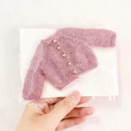 For the Zsiga doll dress it features a stylish pair of sunglasses a pink sweater and a cute design reminiscent of a grandma.